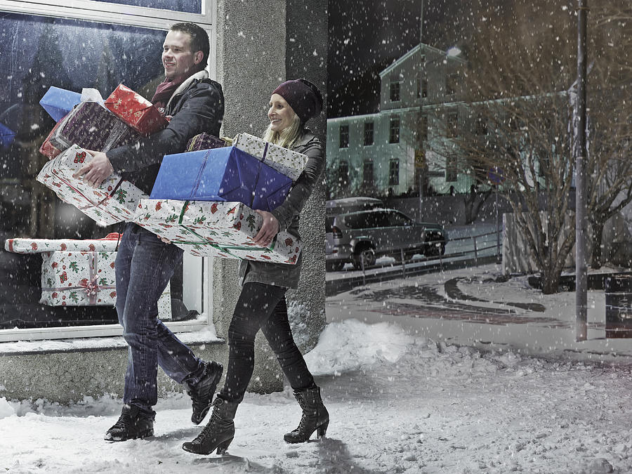 Couple with Christmas gifts in snow Photograph by KMM Productions
