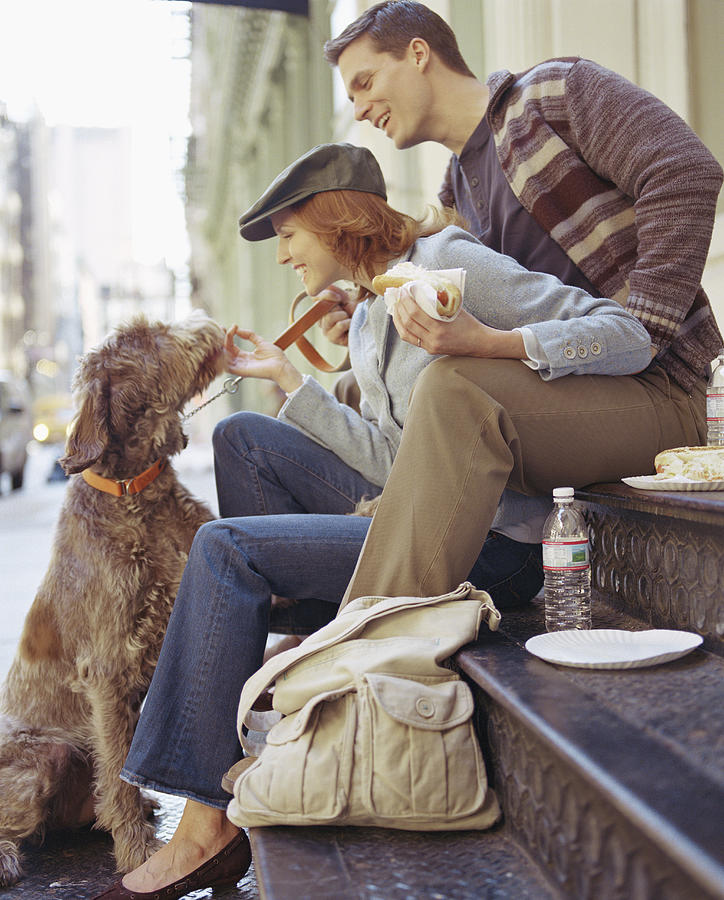 Couple with Dog Enjoying Hot Dogs Photograph by Melanie Acevedo