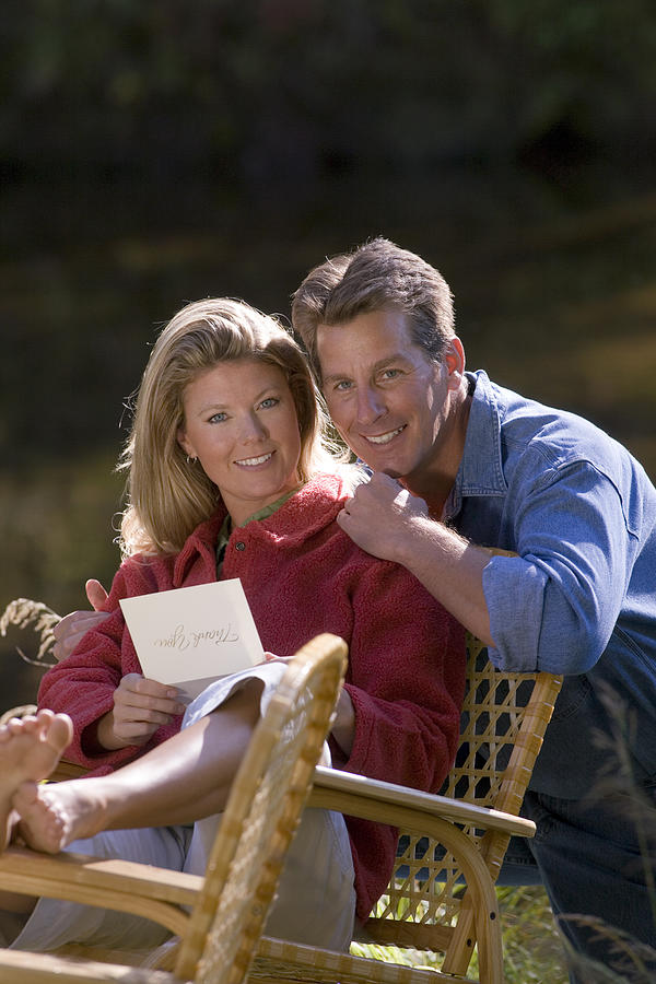 Couple with letter outdoors Photograph by Comstock Images