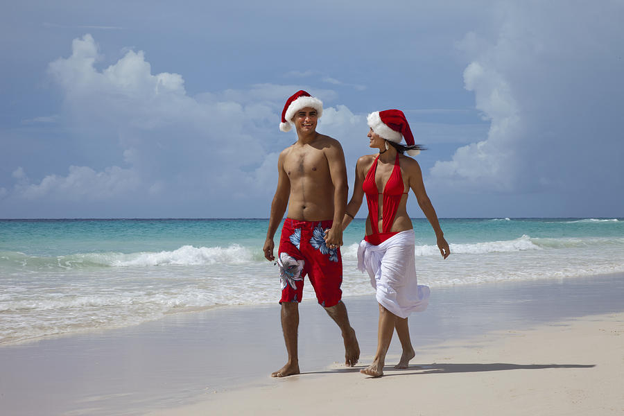 Couple with Santa hat  on a tropical beach Photograph by Buena Vista Images