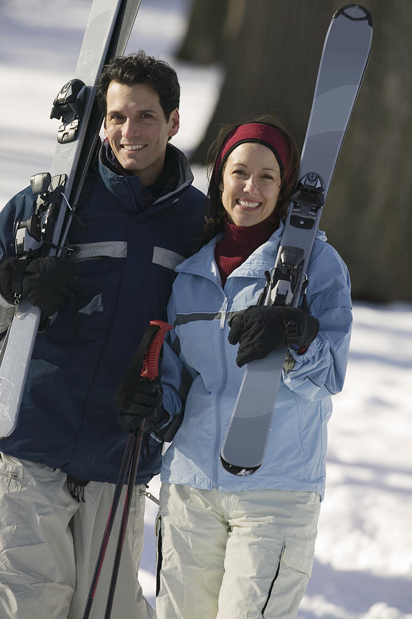 Couple with skis Photograph by Comstock Images