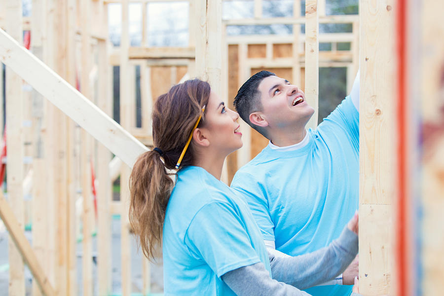 Couple working together to build home for charity Photograph by SDI Productions
