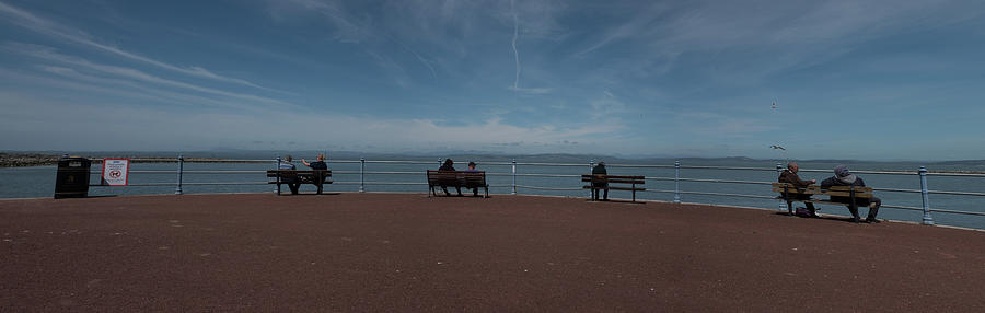 Couples Sat On The Benches By The Sea Photograph