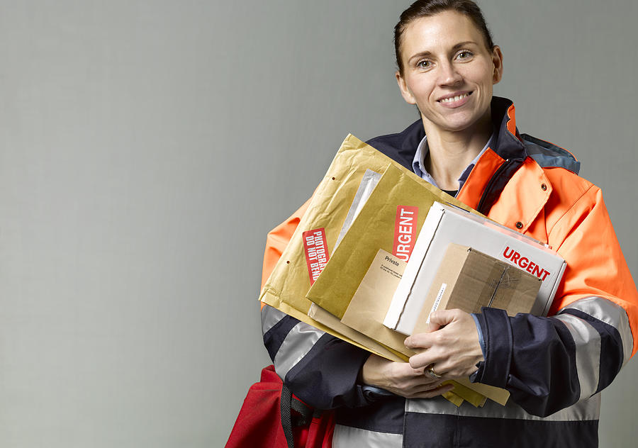 Courier/postwoman with copy space Photograph by Peter Dazeley