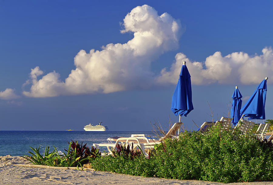 Cozumel Cruise Blues - Cruise ship off the beach of Cozumel Mexico with Blue beach umbrellas Photograph by Peter Herman