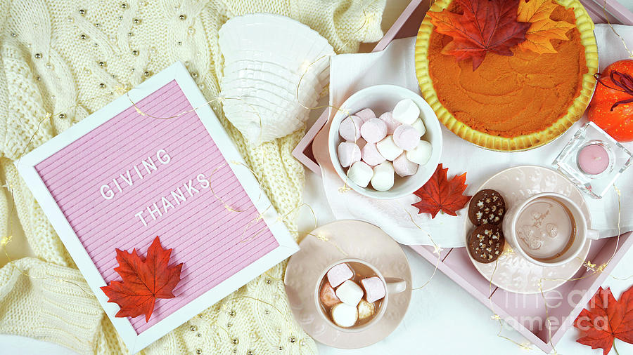 Cozy Thanksgiving flatlay overhead with pumpkin pie and hot chocolate. Photograph by Milleflore Images