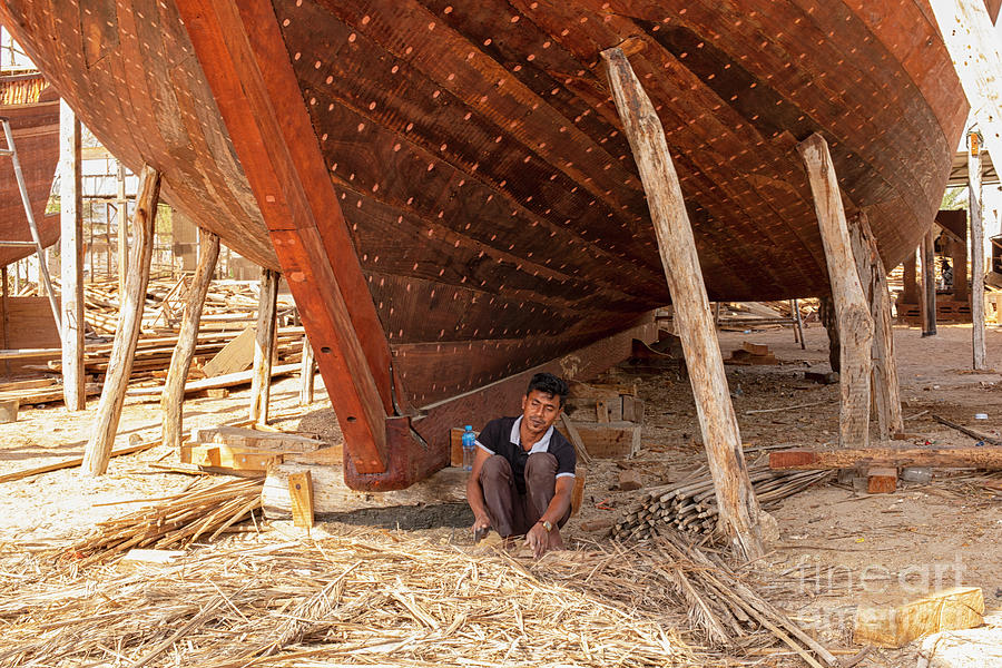 Craftman working on wooden ship in Oman Photograph by Patricia Hofmeester