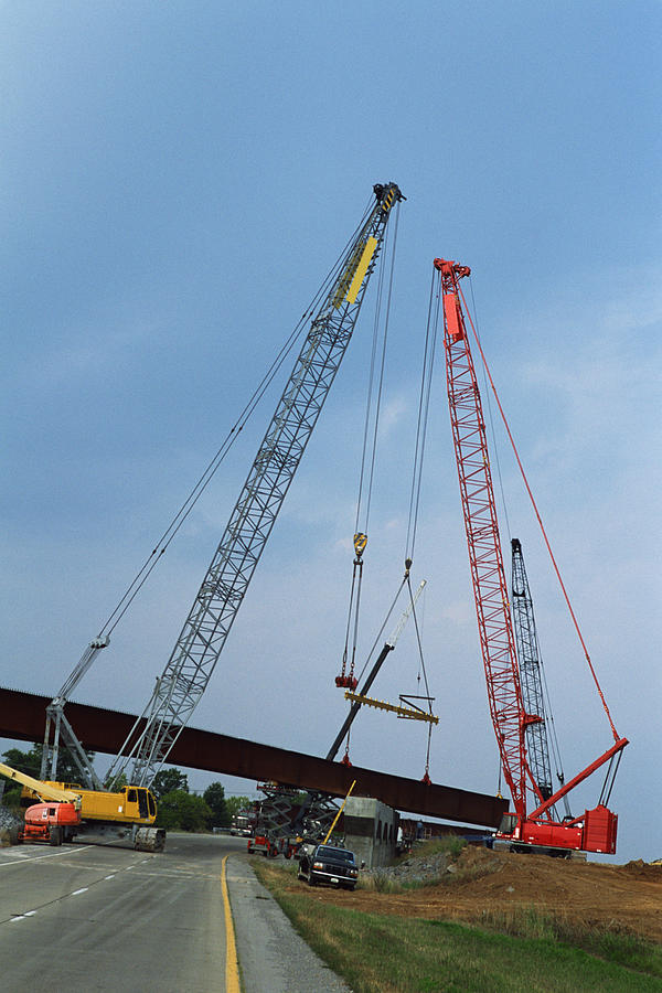 Cranes constructing overpass Photograph by Comstock Images