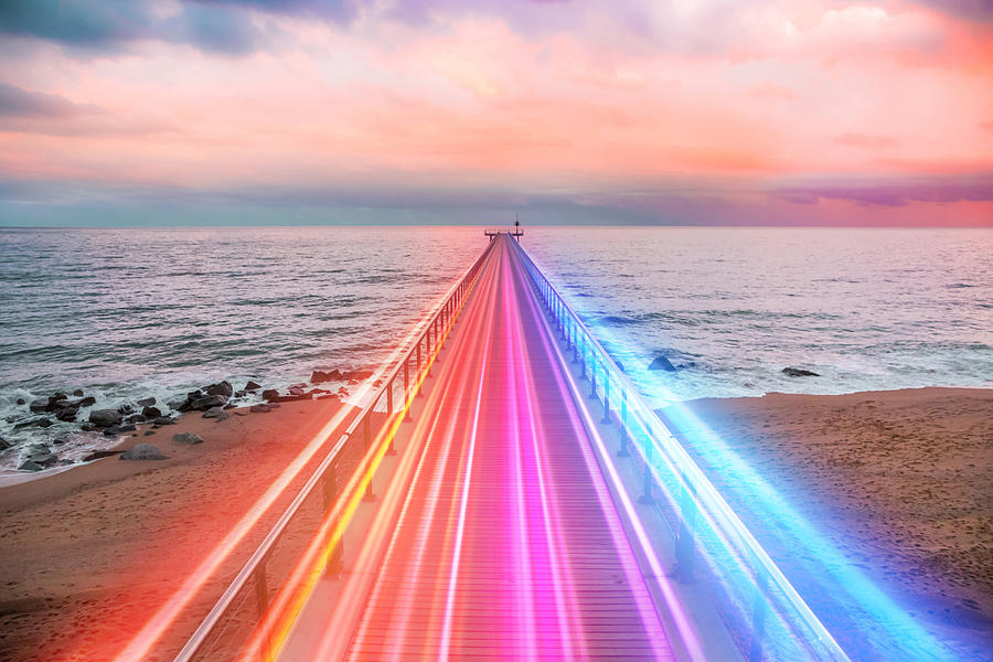 Creative composition of colorful lights trails in motion over the sea. Photograph by Artur Debat