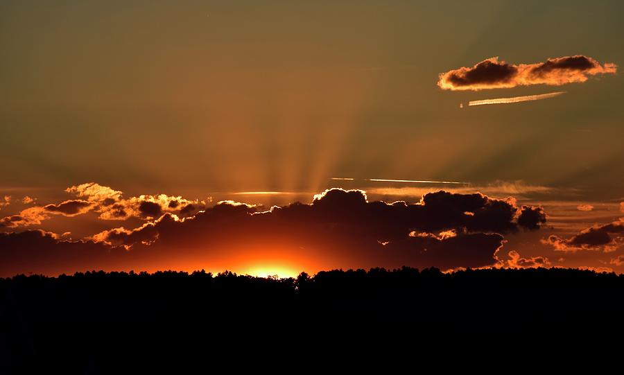 Crepuscular rays at sunset Photograph by Monika Salvan