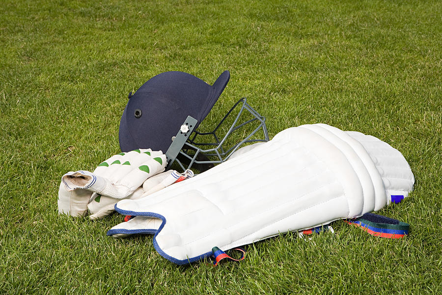 Cricket helmet pads and gloves Photograph by Image Source