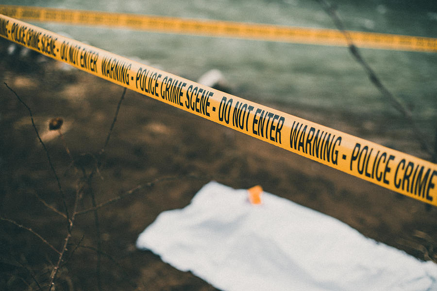 Crime scene with a police barricade tape Photograph by RgStudio