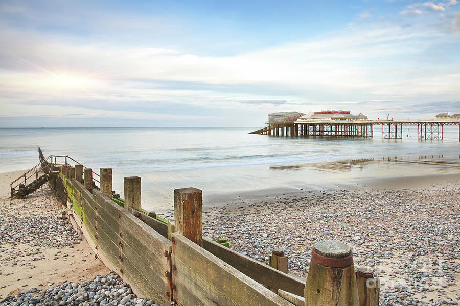 Cromer Pier in Norfolk England with beach groin Photograph by Simon Bratt