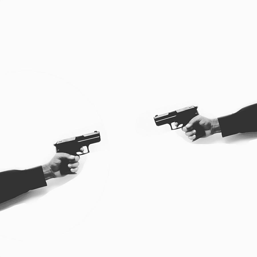 Cropped Hands Holding Handguns Against White Background Photograph by David Muriel Rosales / EyeEm