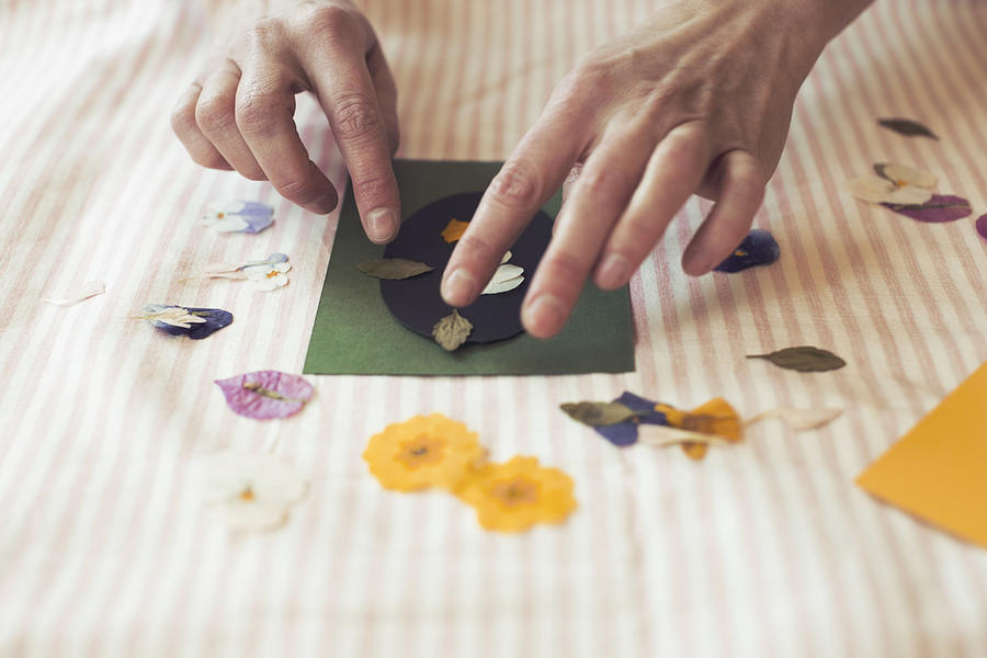 Cropped image of woman making paper craft product on table Photograph by Maskot