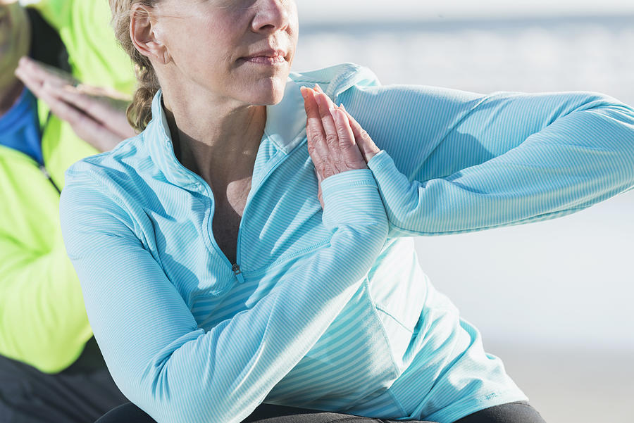Cropped view of mature woman doing yoga Photograph by Kali9