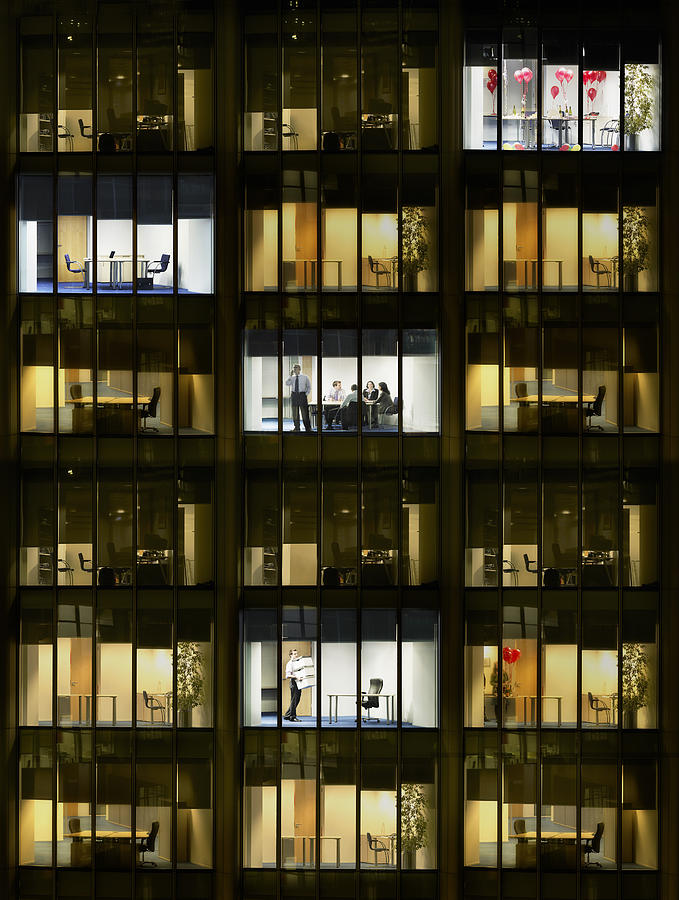 Cross section of office block with people working, view from building exterior (full frame) Photograph by Moodboard