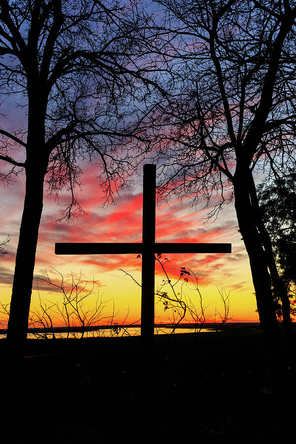 Cross silhouetted against a nice sunset. Photograph by David Ilzhoefer