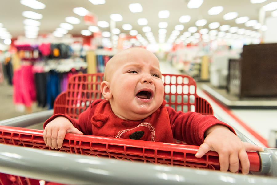 Crying Baby in a shopping cart Photograph by Juanmonino