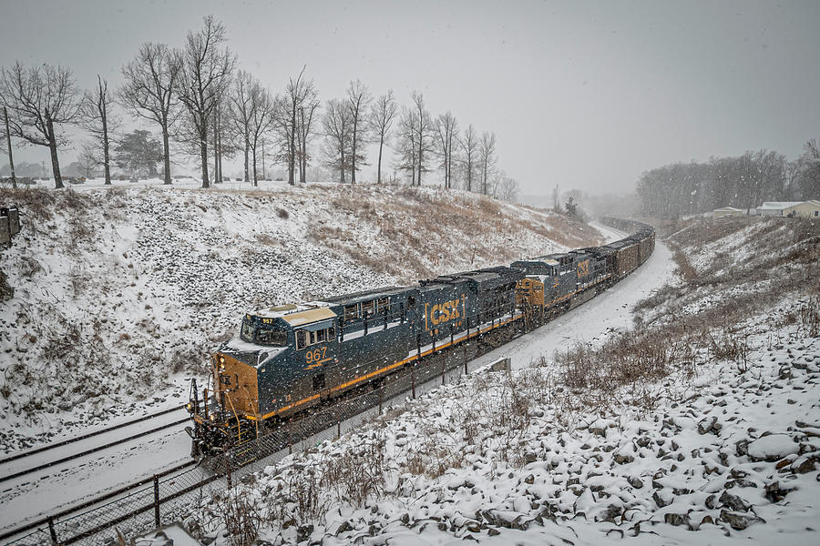 CSX dashing through the snow with a full load of coal Photograph by Jim Pearson