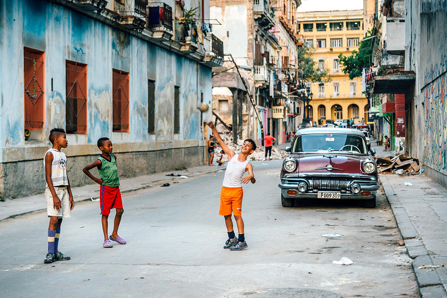Cuban boys playing with ball on a street in Havana Photograph by Nikada