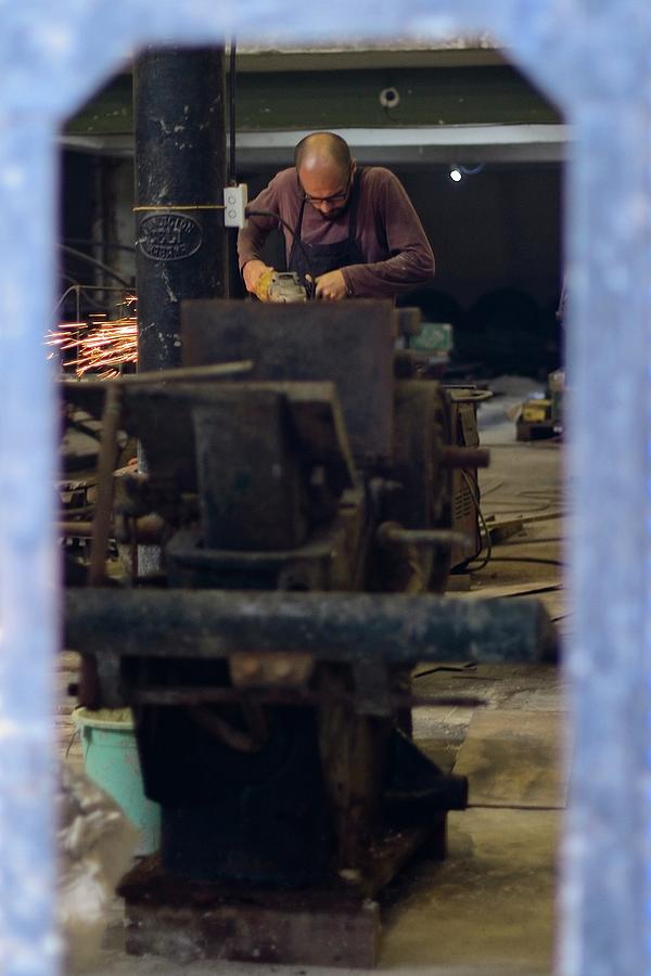 Cuban Metal Worker Photograph by Paul Rebmann