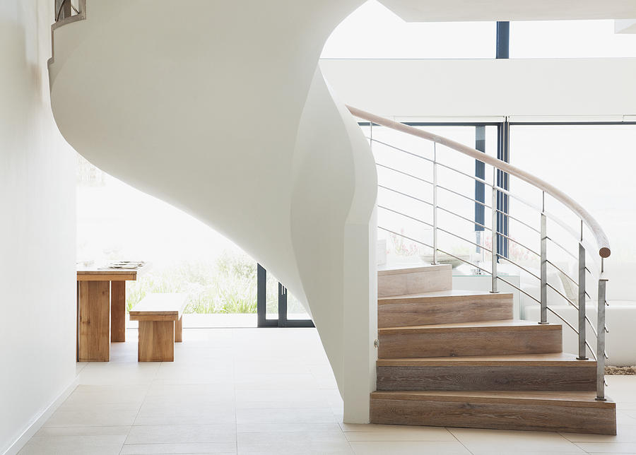 Curving staircase in modern home Photograph by Martin Barraud