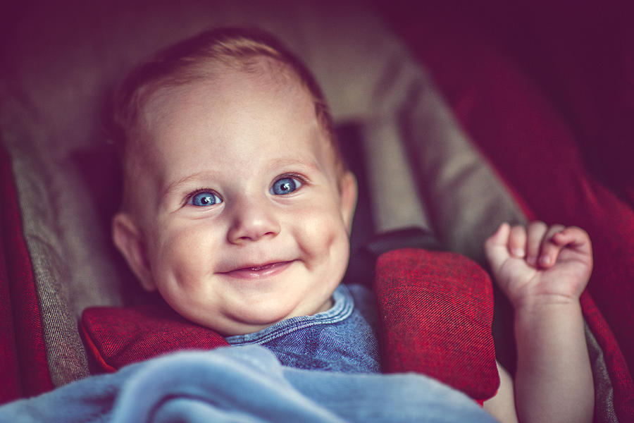 Cute baby boy in stroller smiling Photograph by ArtMarie