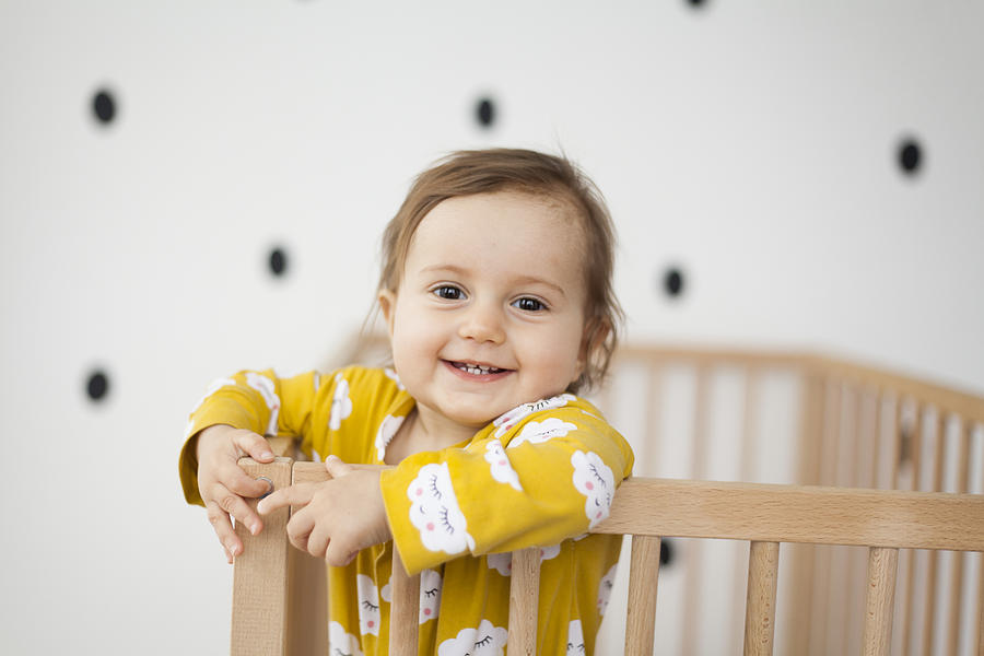Cute Baby Girl In Baby Crib Photograph by Daniela Jovanovska-Hristovska
