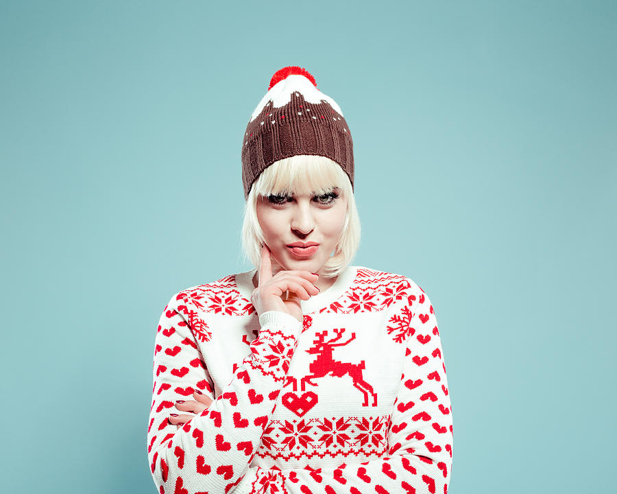 Cute blonde young woman wearing xmas sweater and bobble hat Photograph by Izusek