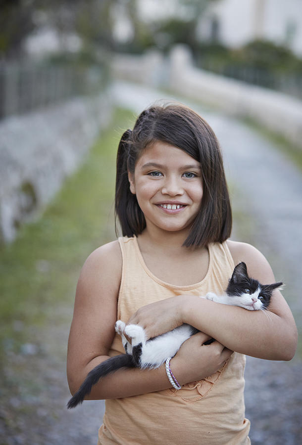 Cute girl holding kitten Photograph by Klaus Vedfelt