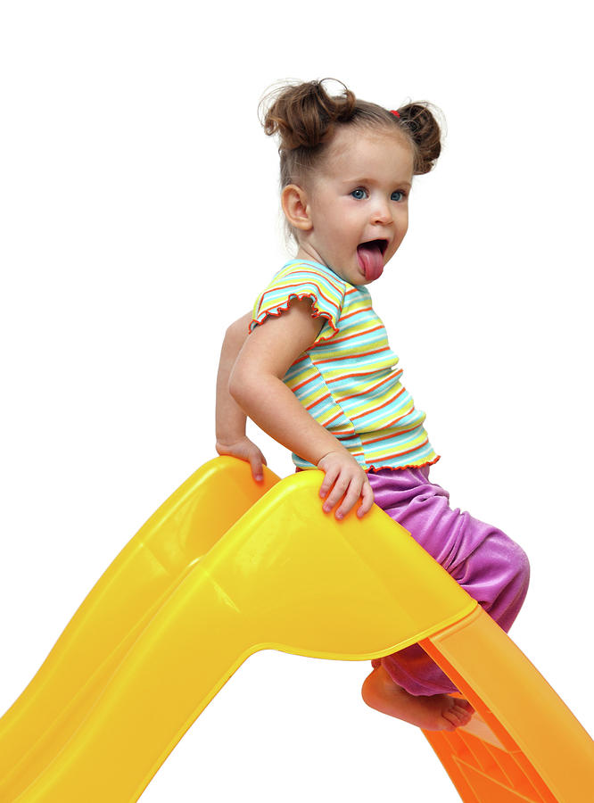 Cute Little Girl On Yellow Slide Photograph by Mikhail Kokhanchikov
