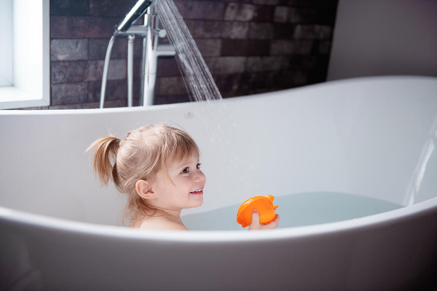 Cute little girl playing in a bathtub Photograph by Manonallard
