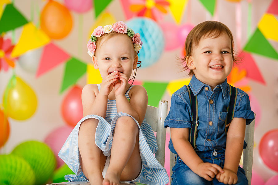 Cute toddler twins at birthday party Photograph by Fotostorm
