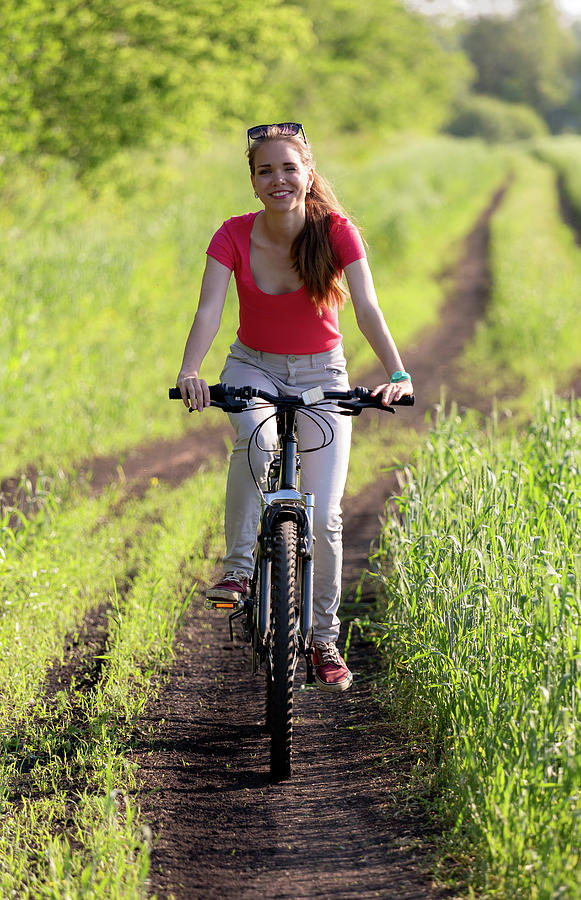 Cute young girl on bicycle Photograph by Mikhail Kokhanchikov