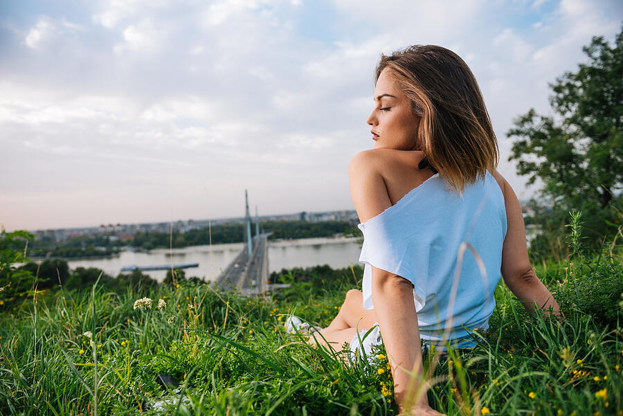 Cute young woman enjoys sunset in summer near Danube river Photograph by Drazen_