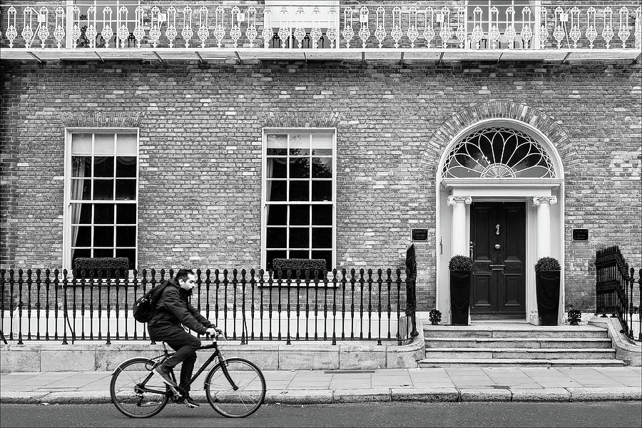 Architecture Photograph - Cyclist on on Merrion Square - Dublin, Ireland by Barry O Carroll