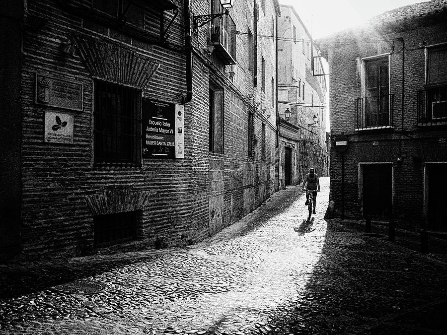 Cyclist Riding a Bicycle on Cobbled Street of Toledo in Spain Photograph by Pak Hong
