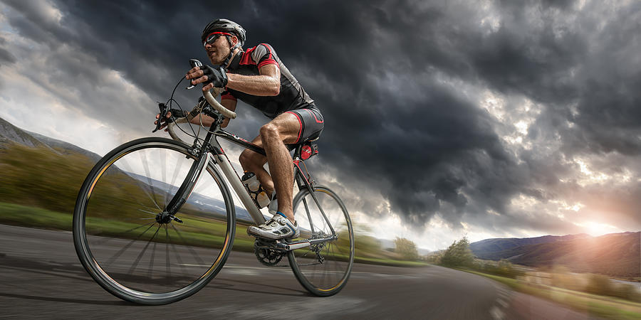 Cyclist Riding Hard To Outrun Storm Photograph by Peepo