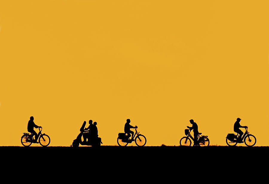 Cyclists and Scooter at Sunset Photograph by Arterra Picture Library