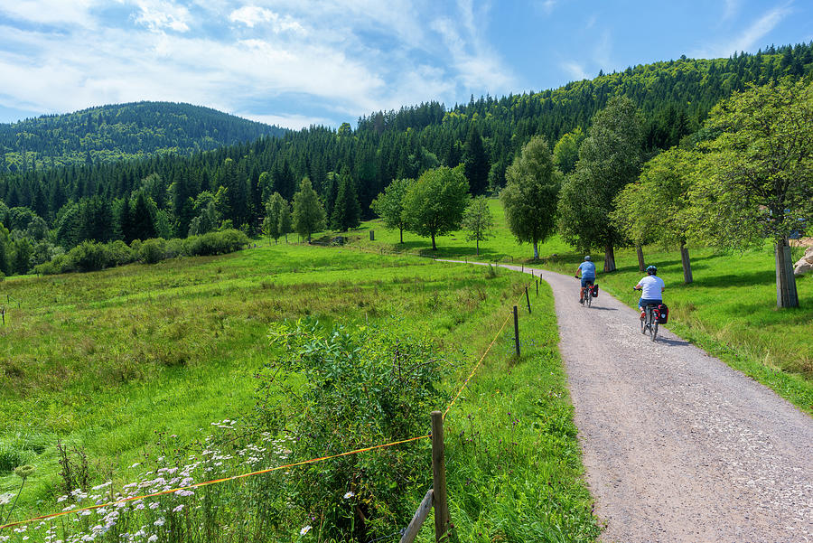 Color Photograph - Cyclists By The Lake Schluchsee by Vicen Photography Color Photograph - Cyclists By The Lake Schluchsee by Vicen Photography