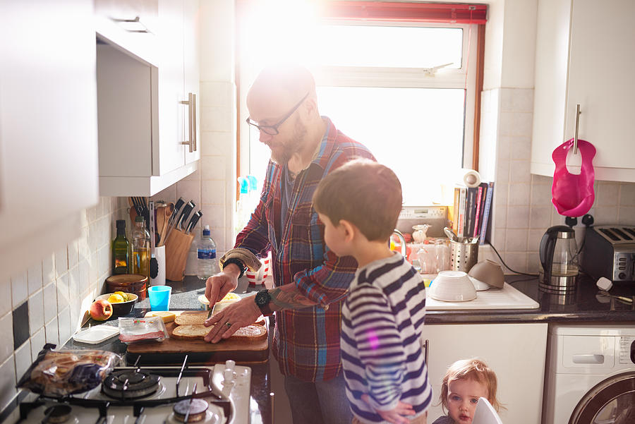 Dad making lunch for his children Photograph by 10000 Hours