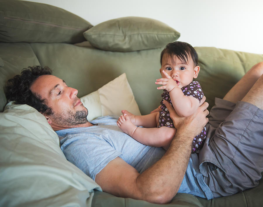 Dad On Couch With Baby Girl Photograph by Layland Masuda