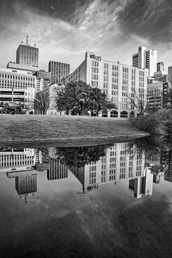 Dallas Texas Skyline On Still Waters At Pioneer Plaza - Black and White Photograph by Gregory Ballos