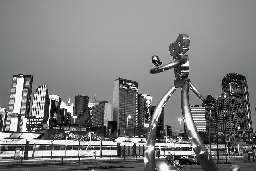 Dallas Traveling Man and Skyline - Black and White Photograph by Gregory Ballos