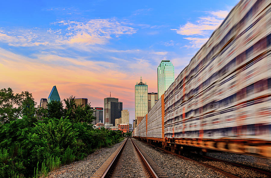 Dallas, TX skyline during a sunset with a traveling train. Photograph by David Ilzhoefer