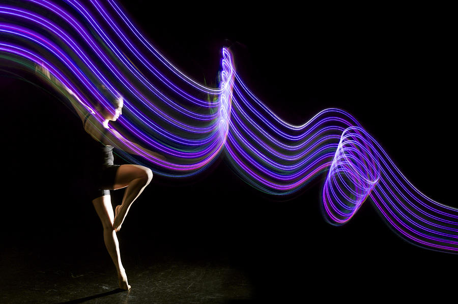 Dancer Pirouettes In Beam Of Parallel Purple Light Photograph by John Rensten