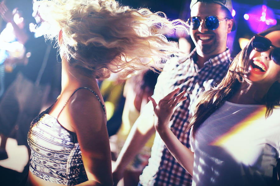Dancing in a nightclub. Photograph by Gilaxia