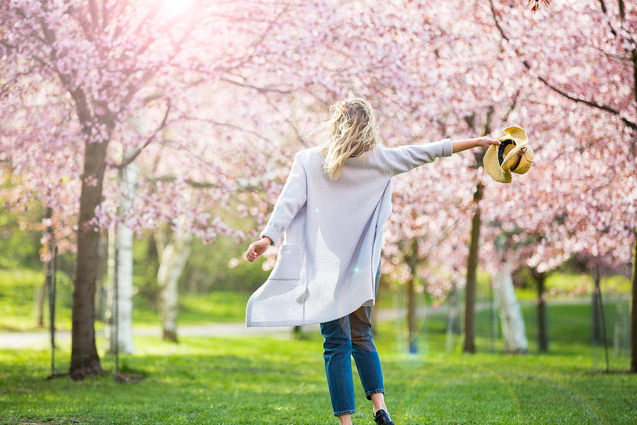 Dancing, running and whirling in beautiful park with cherry trees in bloom Photograph by Sasha_Suzi