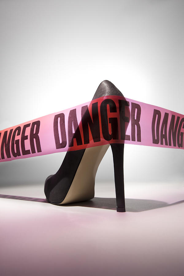 Danger tape around stiletto heel Photograph by Tooga